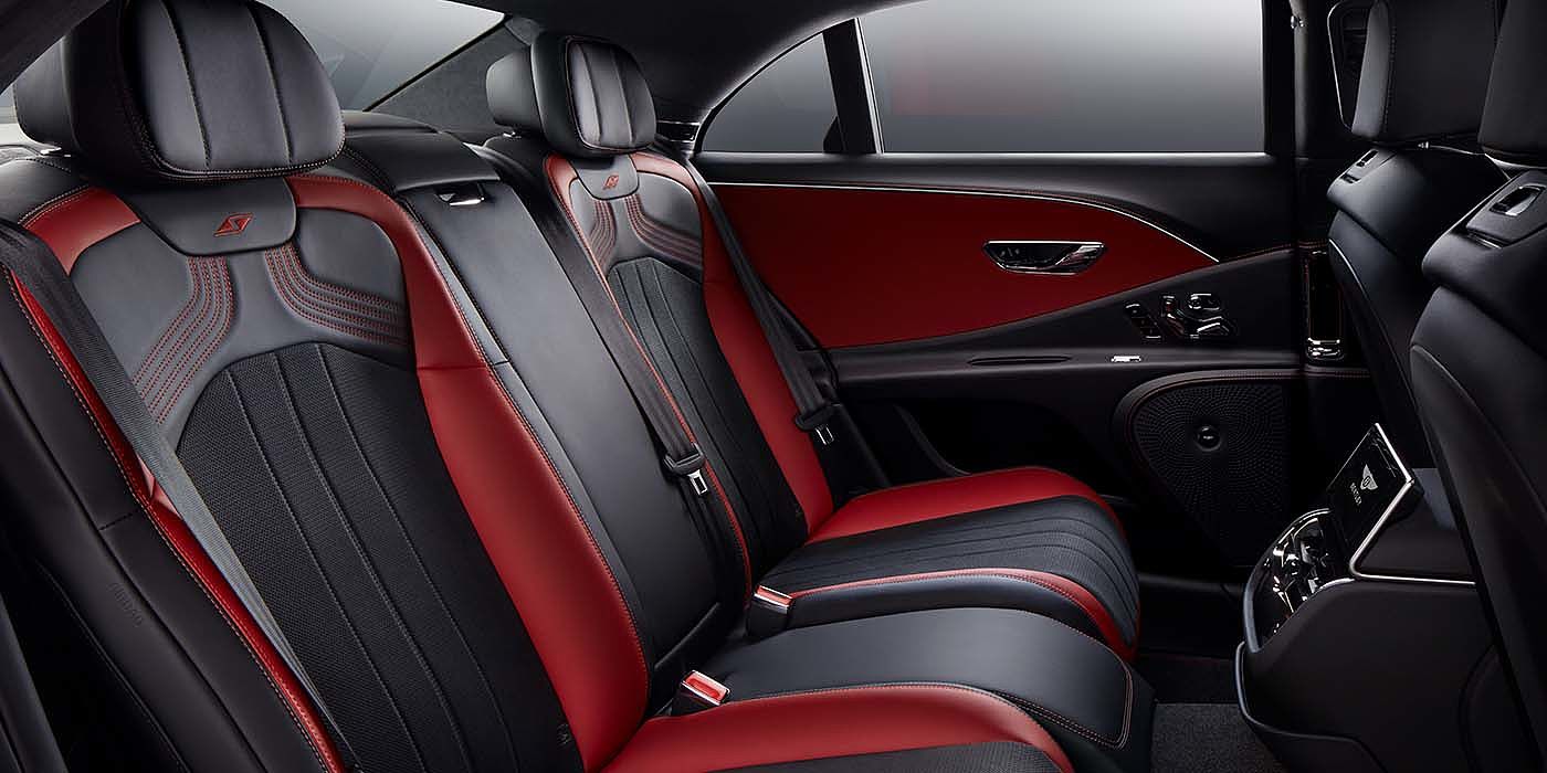 Bentley Auckland Bentley Flying Spur S sedan rear interior in Beluga black and Hotspur red hide with S stitching