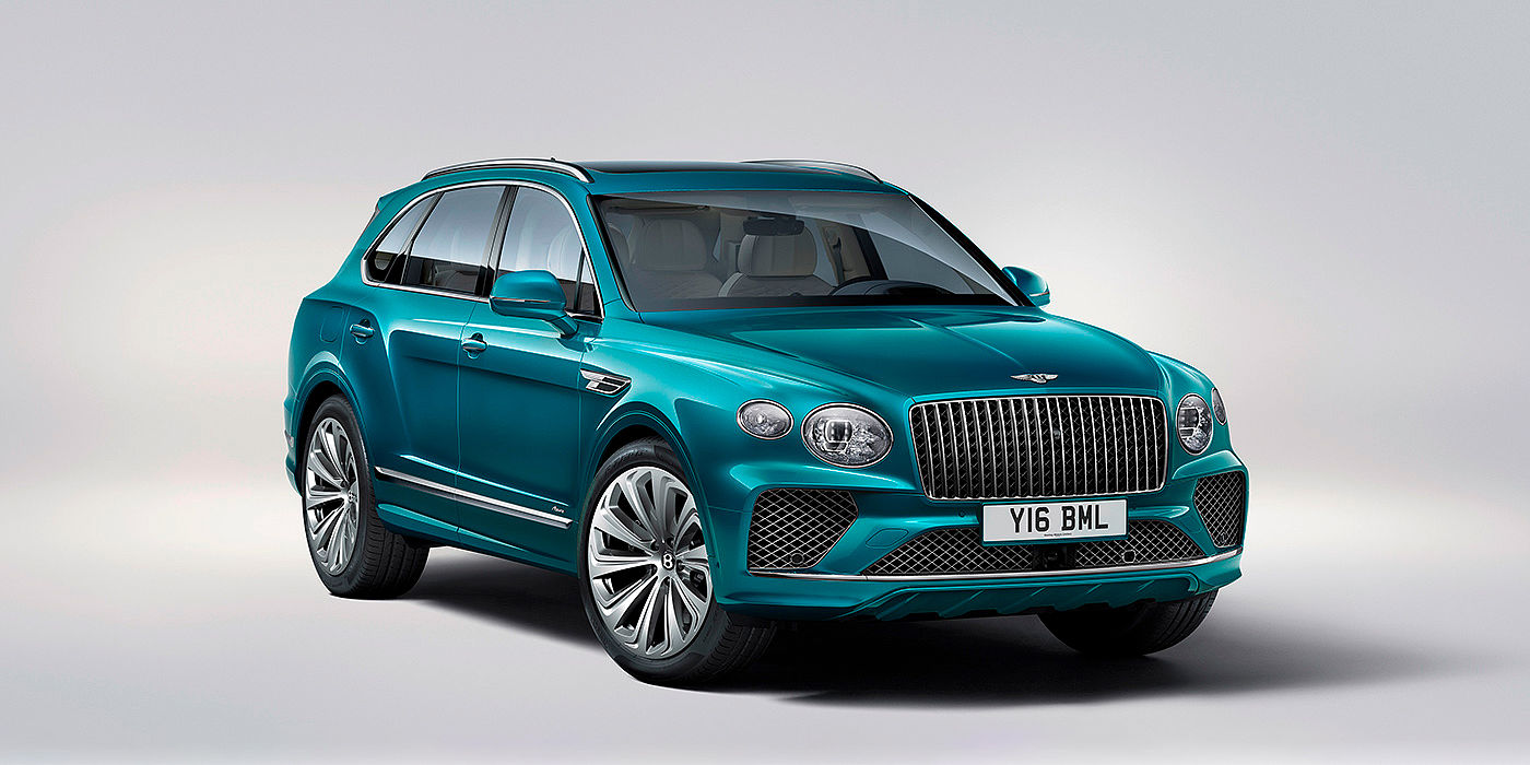 Bentley Auckland Bentley Bentayga Azure front three-quarter view, featuring a fluted chrome grille with a matrix lower grille and chrome accents in Topaz blue paint.