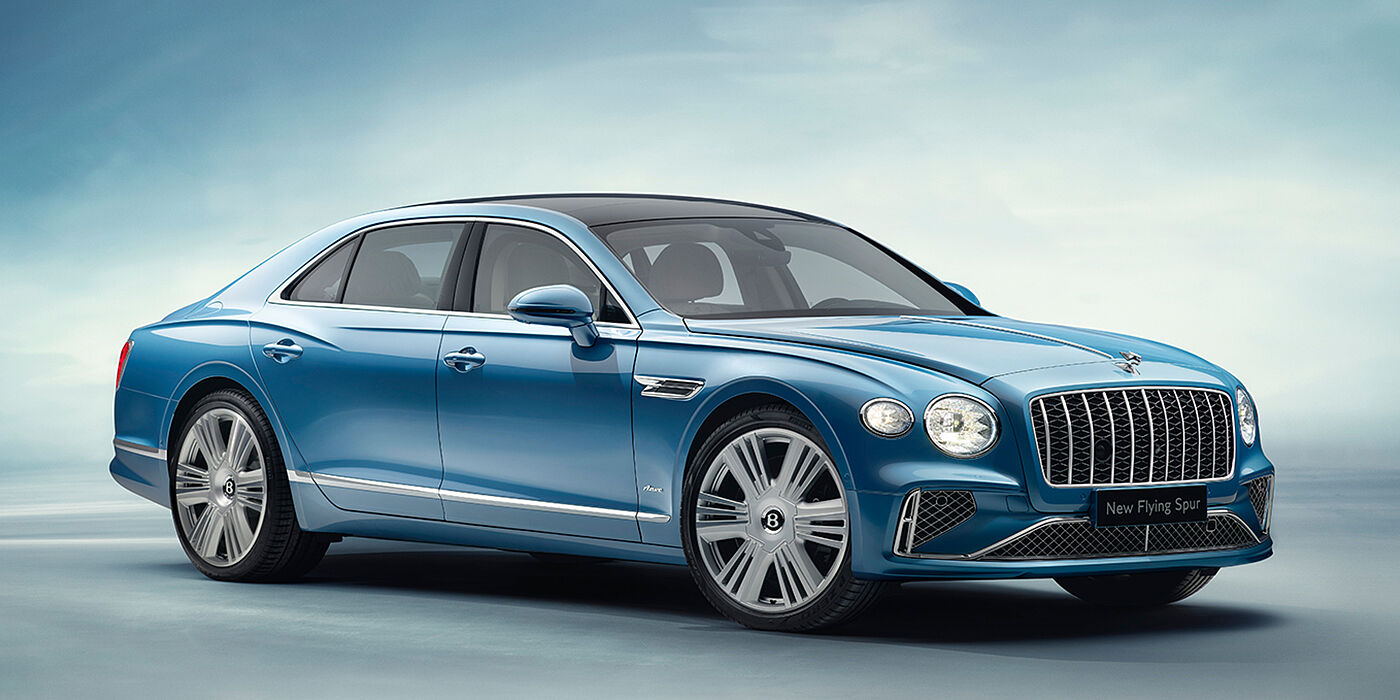 Bentley Auckland New Bentley Flying Spur Azure sedan front view in Light windsor blue by Mulliner paint with 22 inch Azure wheels and chrome exterior details