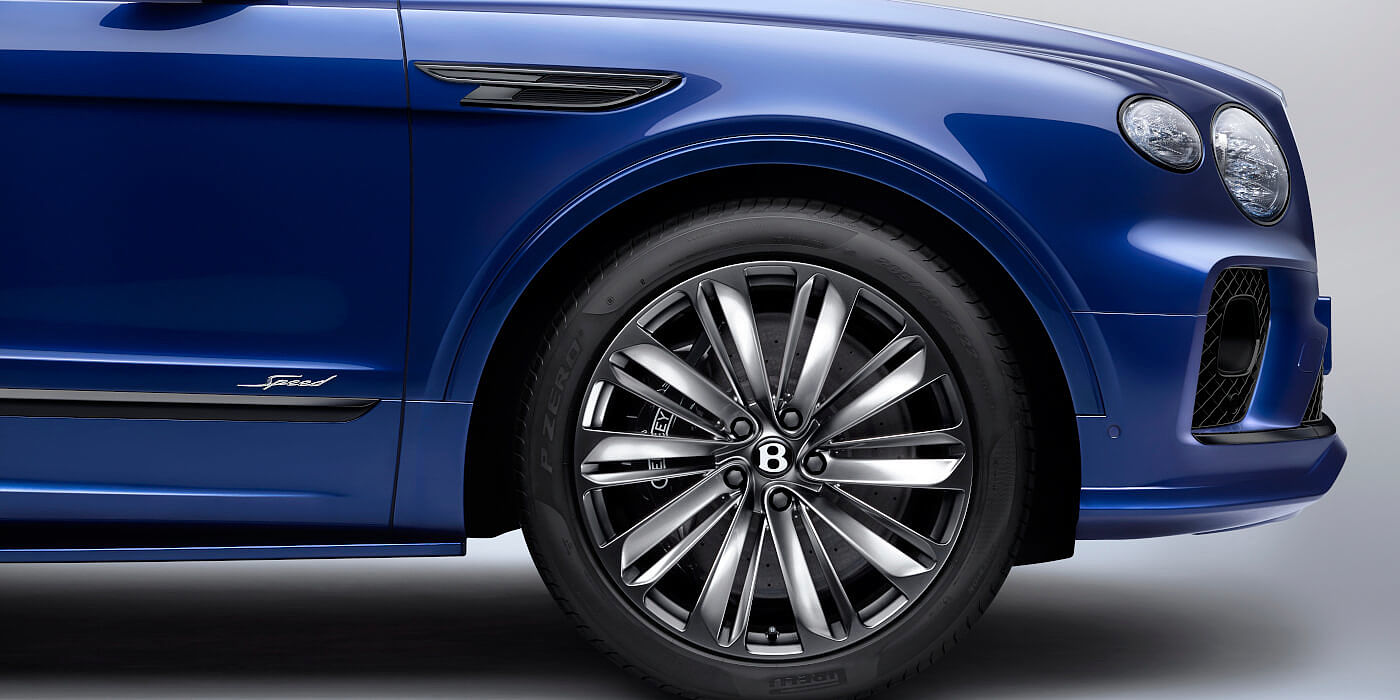 Bentley Auckland Bentley Bentayga Speed SUV in Moroccan Blue paint with chrome badge and front wheel close up