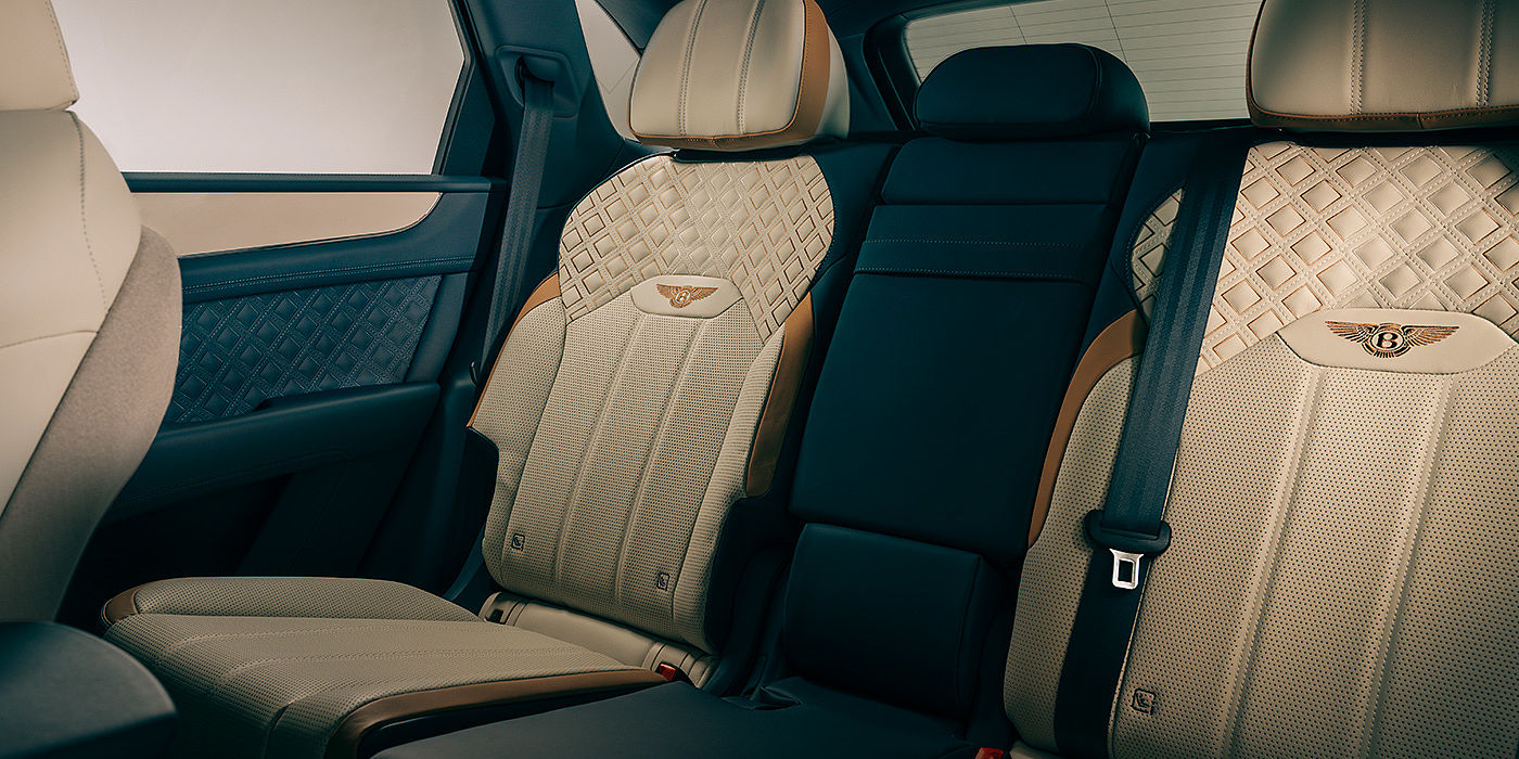 Bentley Auckland Bentley Bentayga Odyssean Edition SUV rear interior in Linen and Brunel hides with diamond in diamond seat stitching