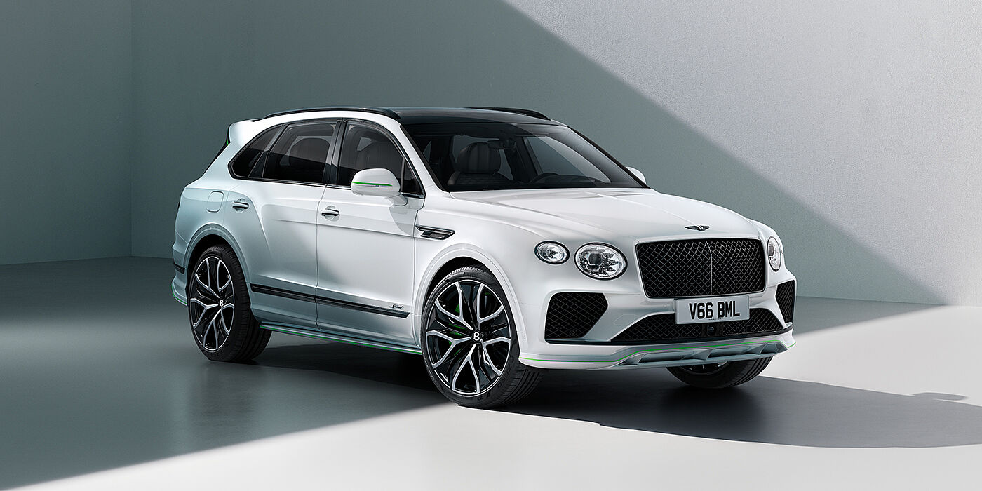 Bentley Auckland Bentley Bentayga Speed SUV front three quarter in Snow Quartz Pearlescent by Mulliner white paint against a grey wall