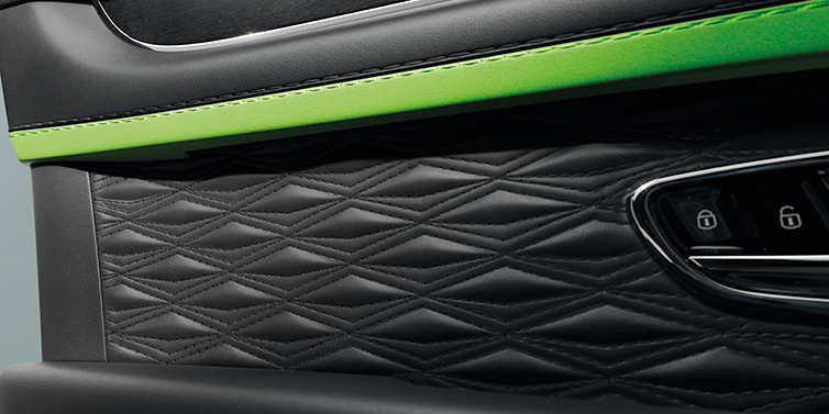 Bentley Auckland Bentley Bentayga Speed SUV interior door detail with Diamond in Diamond stitched hide in Beluga black colour, with Black stained Crown Cut Walnut veneer