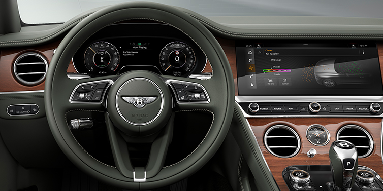 Bentley Auckland New Bentley Continental GT coupe steering wheel and front cabin view in Cumbrian Green hide and Crown Cut walnut veneer